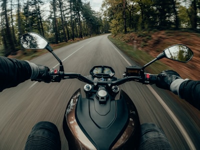 Rider’s view from a motorbike winding through the scenic roads of the UK countryside.