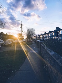 A technician installing fiber optic cables on a residential street at sunset.