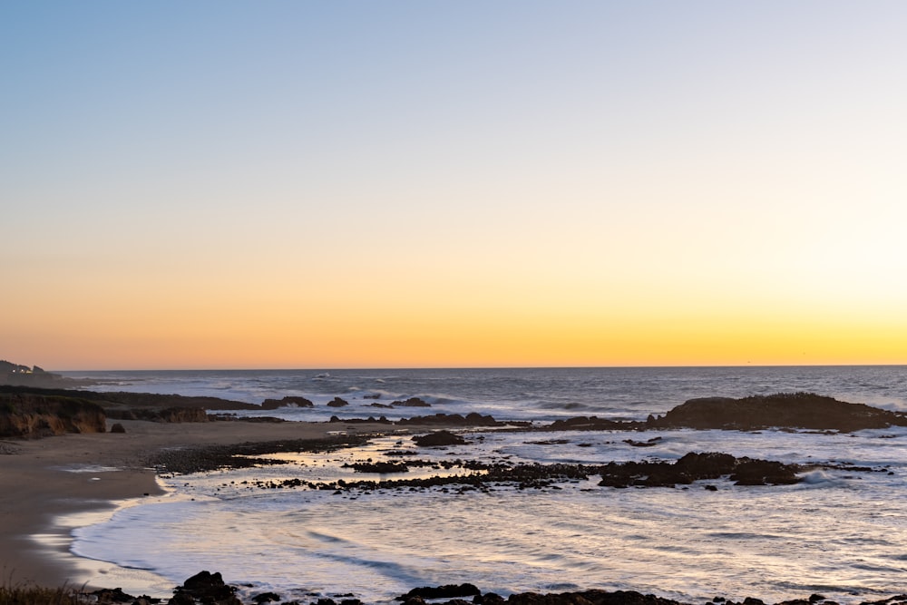 silhouette of people on beach during sunset