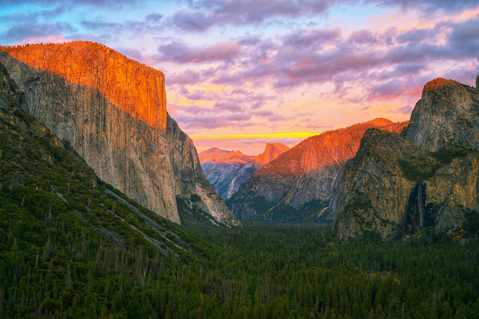 The Yosemite valley at sunrise, El Capitan on the left and Half Dome behind