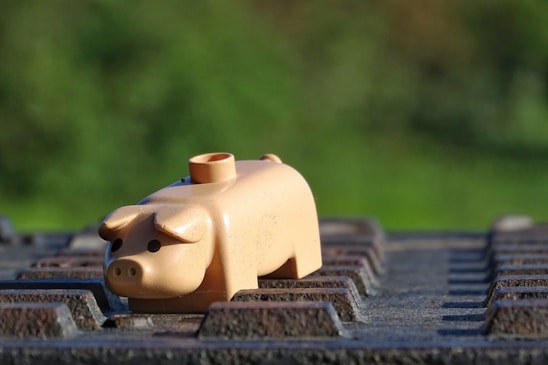 Animated pig character causing playful chaos with wooden crates and scrap metal background.