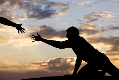 An inspiring sunset view symbolizing vision, with hands reaching toward the horizon.