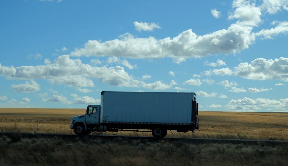 a truck driving down the road in the middle of nowhere