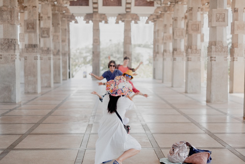 woman in red and blue dress dancing on white floor tiles during daytime