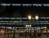 Evening scene with decorative lights illuminating the plaza during a cultural festival.