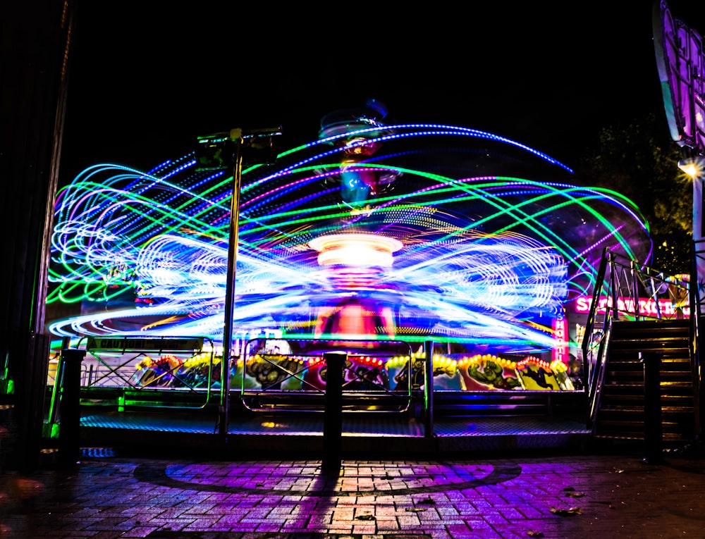 a carnival ride at night with colorful lights