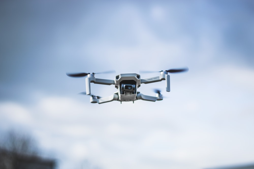 black and gray drone flying in the sky