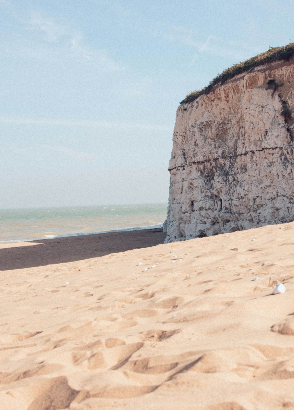 brown rock formation near body of water during daytime