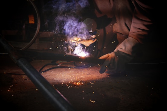 a person working on a piece of metal