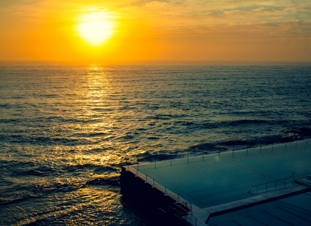 body of water during sunset