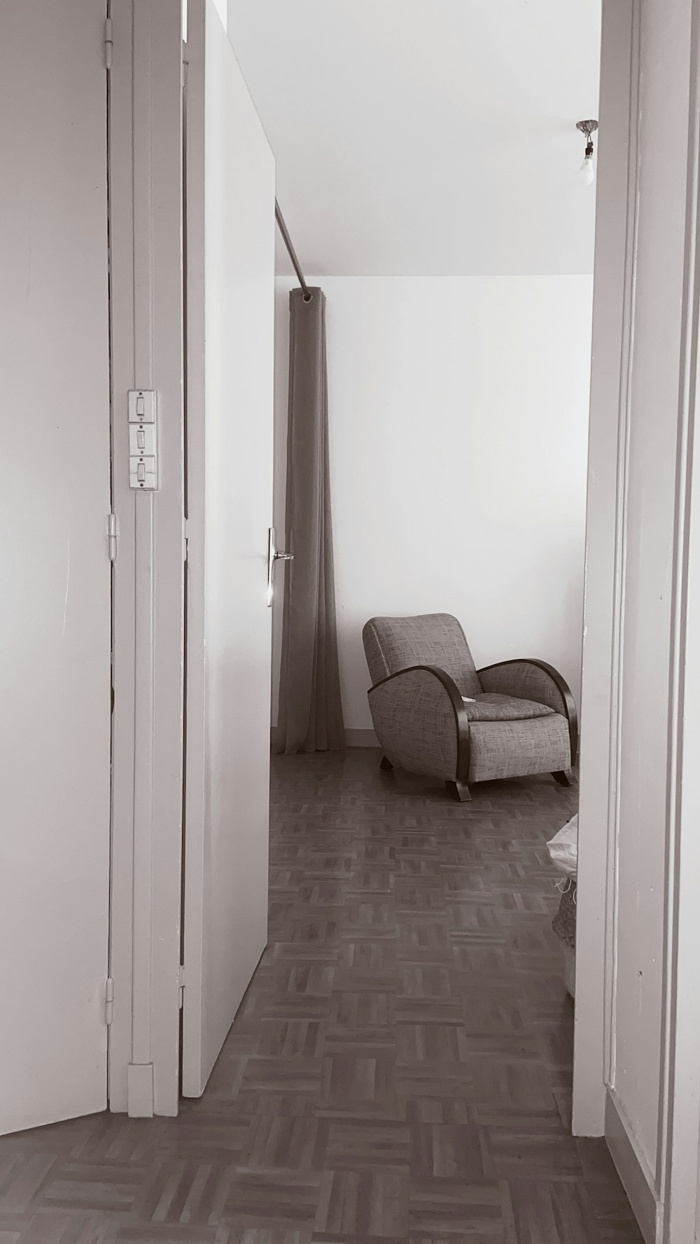 white wooden door near brown and white armchair