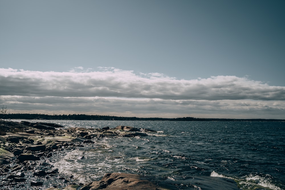 body of water under blue sky during daytime