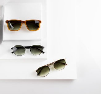 black framed sunglasses on white table