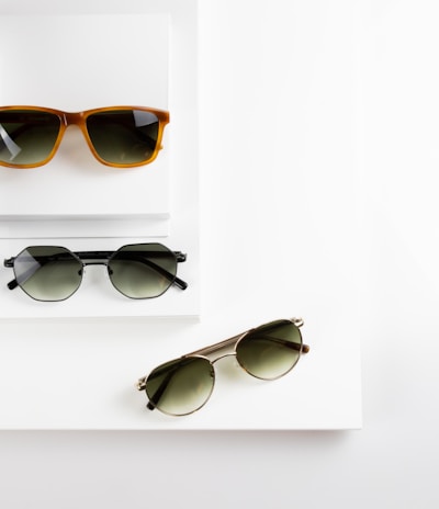 black framed sunglasses on white table