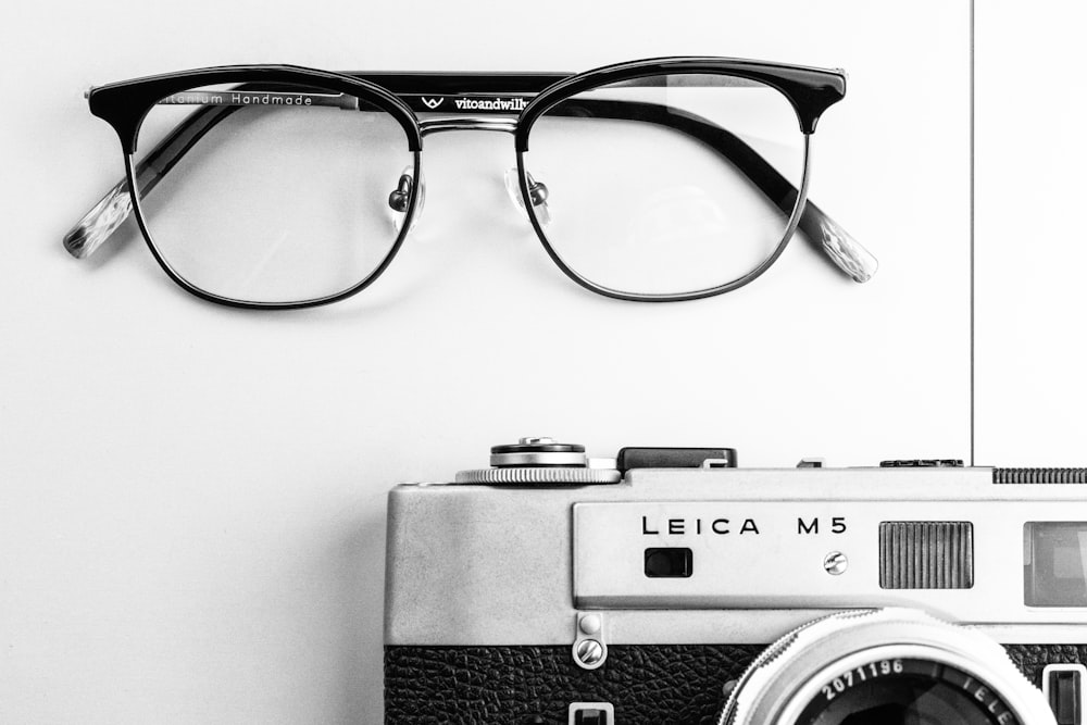 black and silver camera on white table