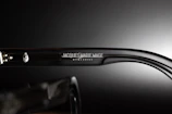 Close-up of premium branded glasses with intricate detailing and polished metal temples.