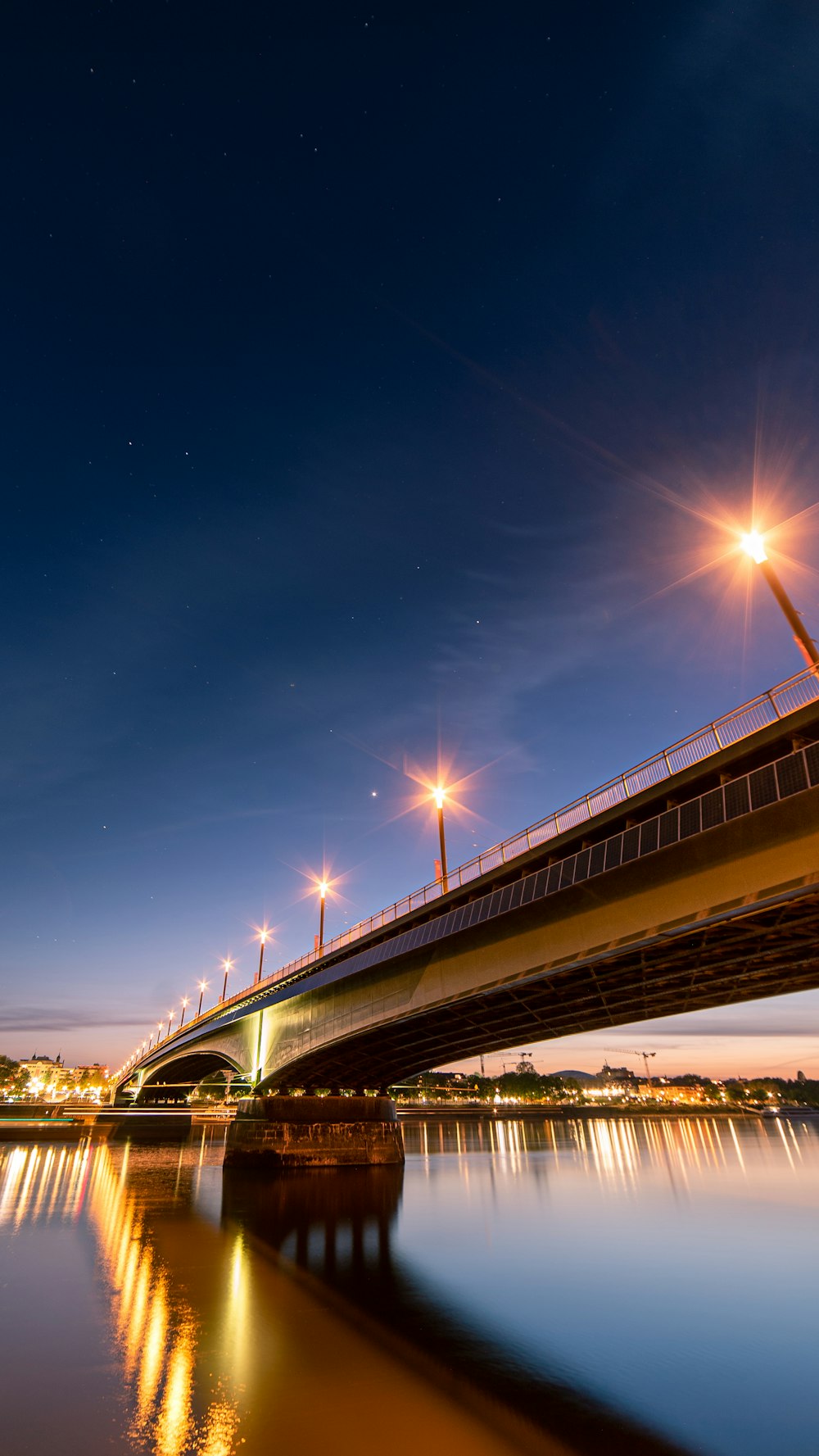 white and brown bridge under blue sky during night time