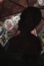 A golden umbrella shielding a group of people from a stormy, dark background.