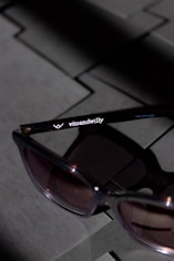black framed sunglasses on gray textile