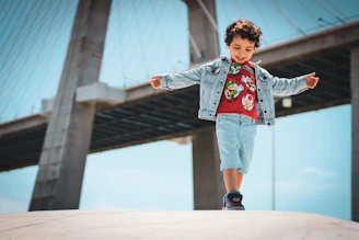 a little boy that is standing on a ledge