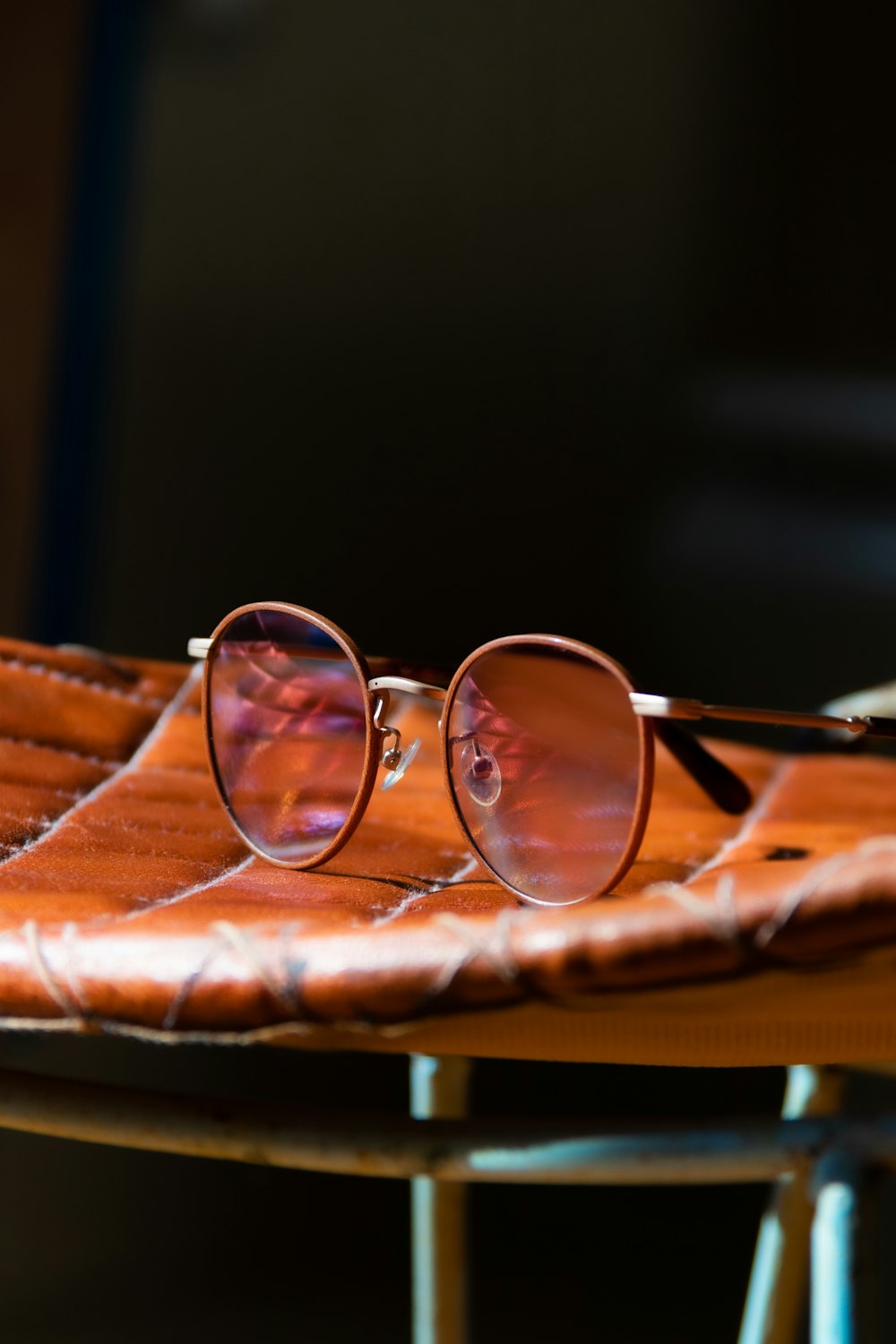 brown framed eyeglasses on brown wooden table