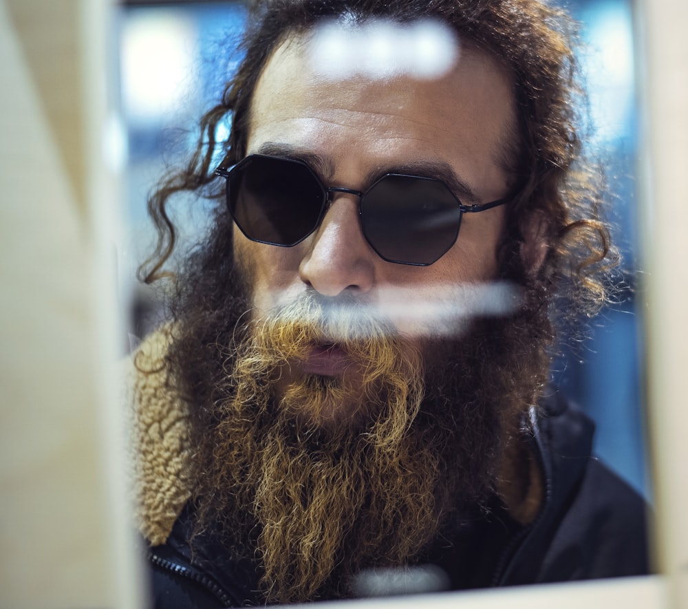 man in black leather jacket wearing black sunglasses