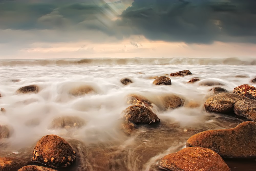 brown rock formation on sea water during daytime