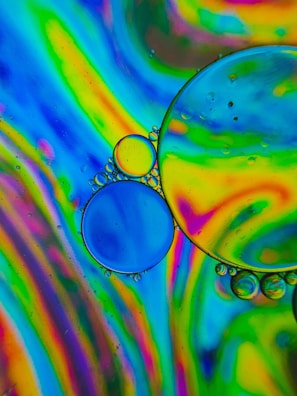 Rainbow swirl slime twisted into a playful spiral on a white background.