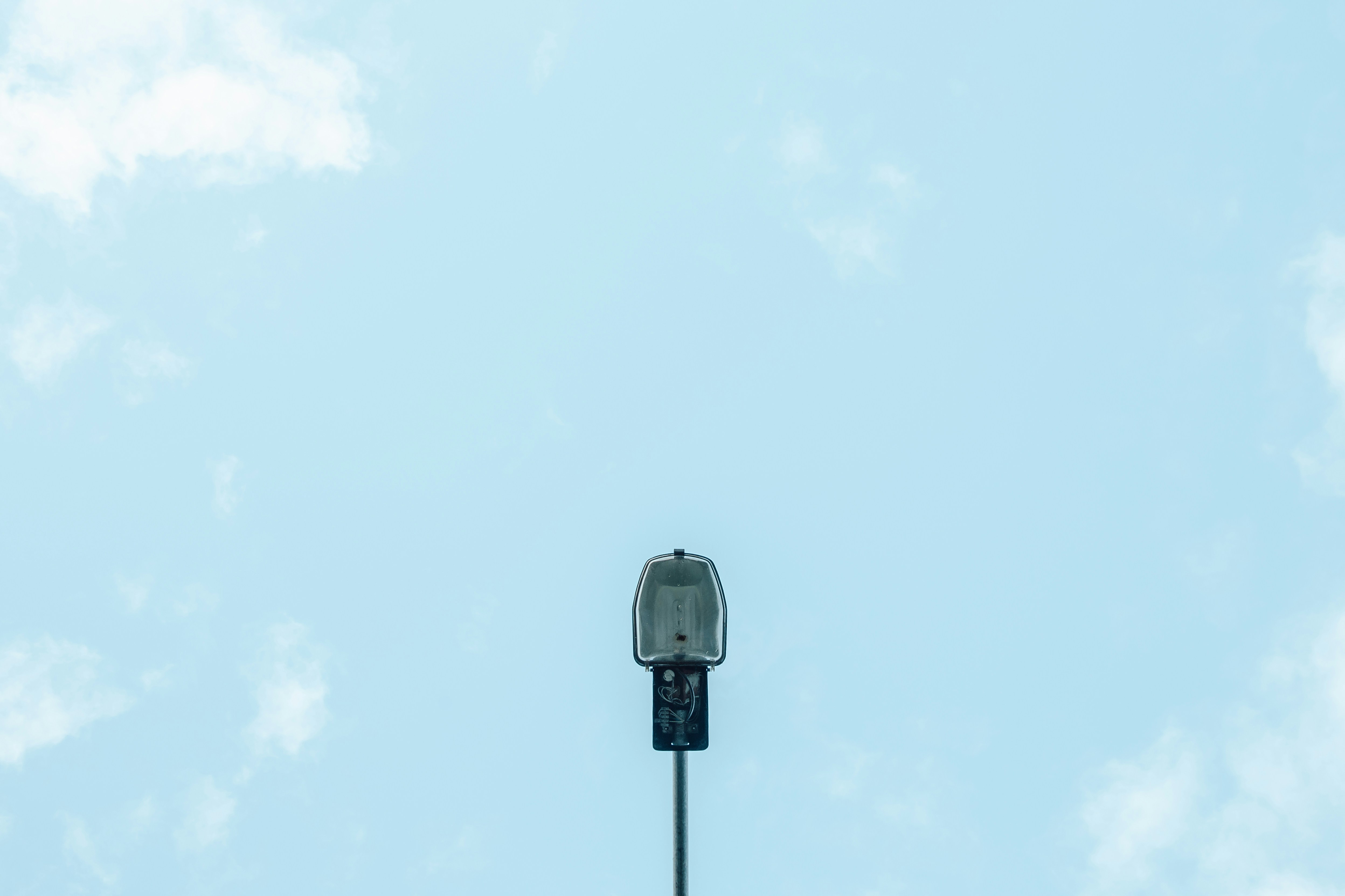 black and white street light under blue sky during daytime