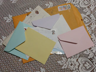 brown and white envelope on white and brown textile