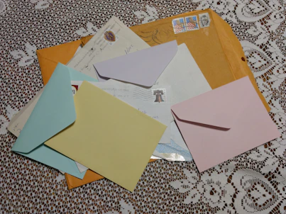 brown and white envelope on white and brown textile