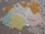 Several colorful envelopes and letters are scattered on a white lace tablecloth. The envelopes include blue, yellow, pink, and brown colors with postal stamps visible on some of them.