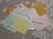 Several colorful envelopes and letters are scattered on a white lace tablecloth. The envelopes include blue, yellow, pink, and brown colors with postal stamps visible on some of them.