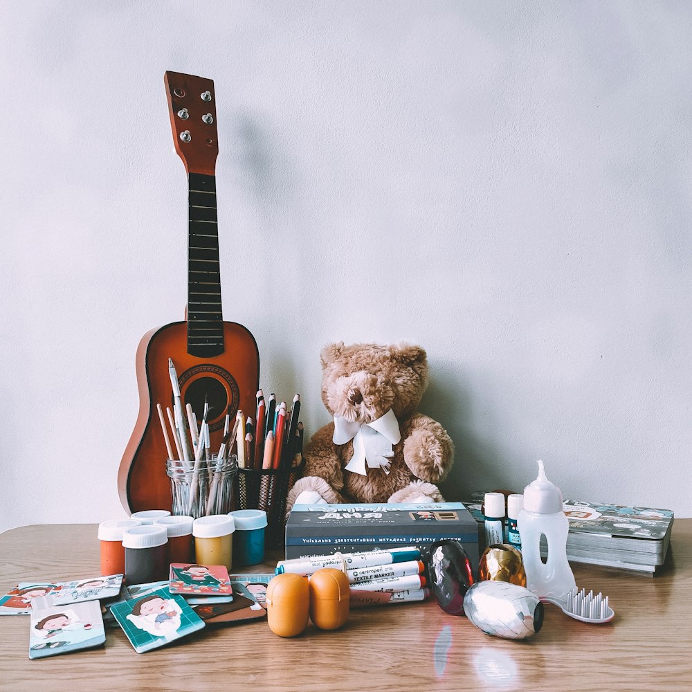 brown acoustic guitar on white wall