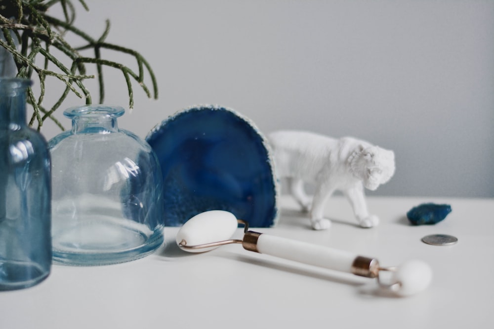 white bear plush toy beside blue glass ball