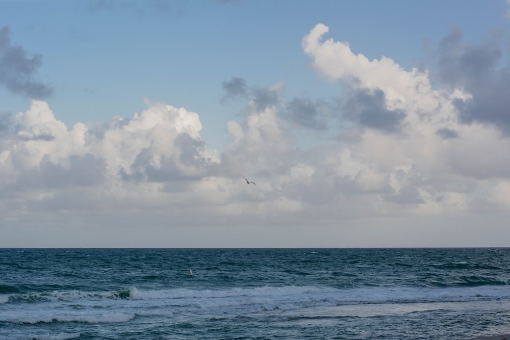 blue sea under blue sky and white clouds during daytime