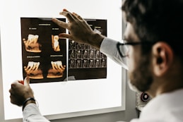 person in gray long sleeve shirt holding black tablet computer