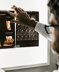 person in gray long sleeve shirt holding black tablet computer