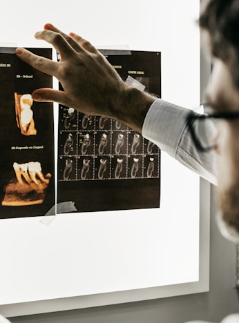 person in gray long sleeve shirt holding black tablet computer