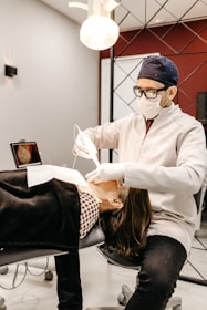 woman in white long sleeve shirt sitting on black and white polka dot chair