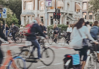 people riding bicycle on road during daytime