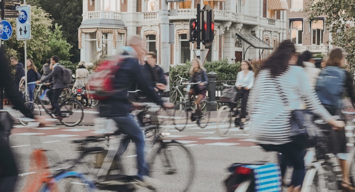 people riding bicycle on road during daytime