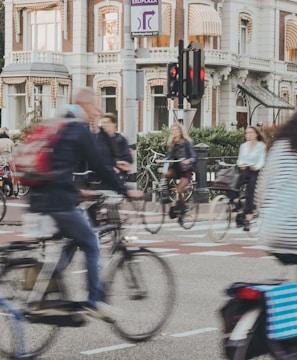 people riding bicycle on road during daytime