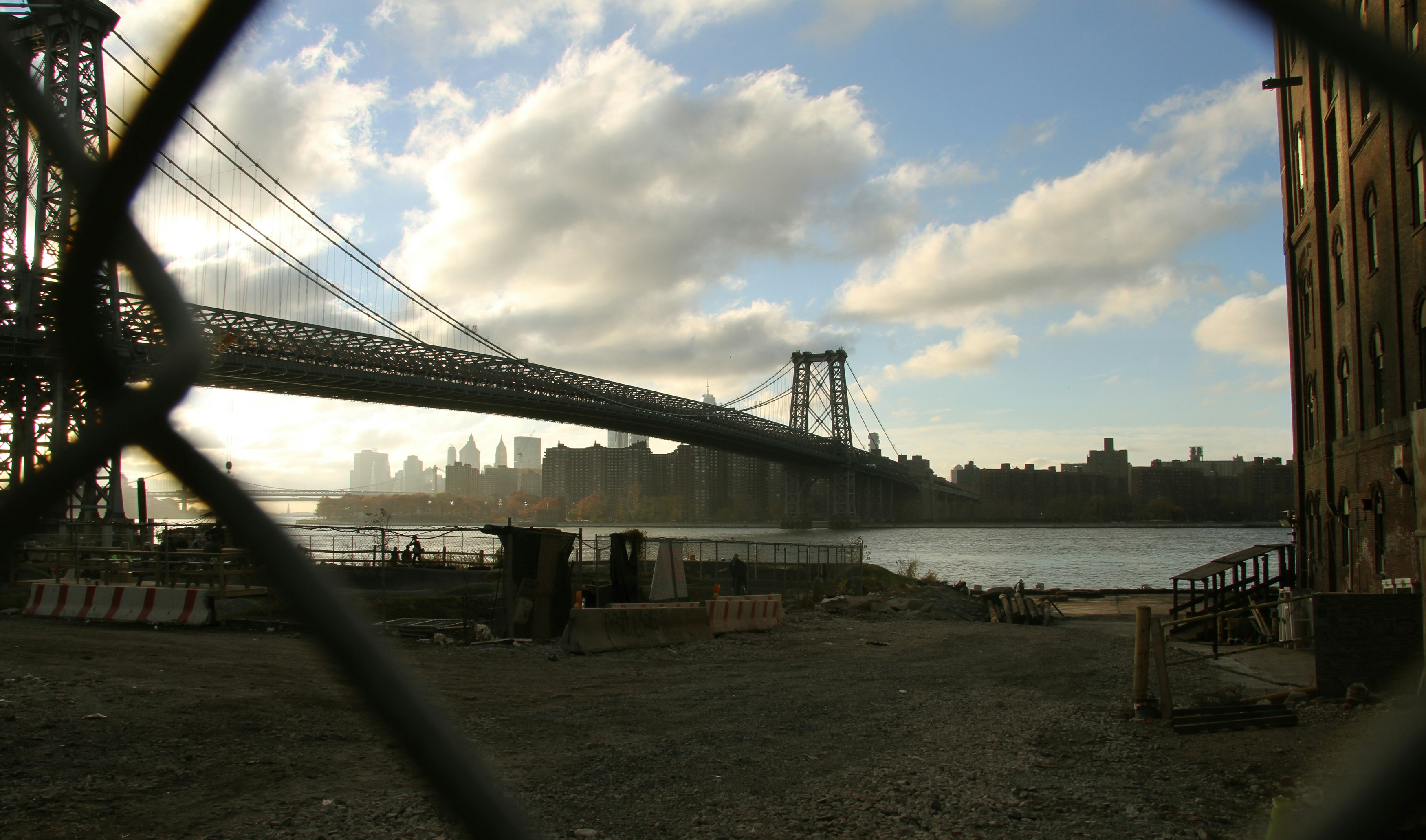bridge over the sea under white clouds and blue sky during daytime