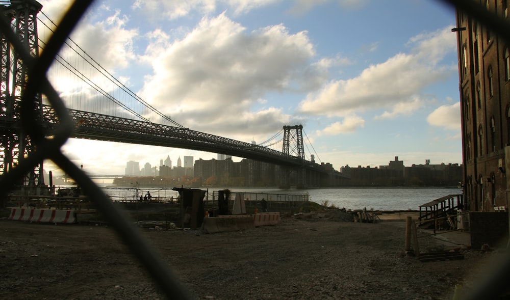 bridge over the sea under white clouds and blue sky during daytime