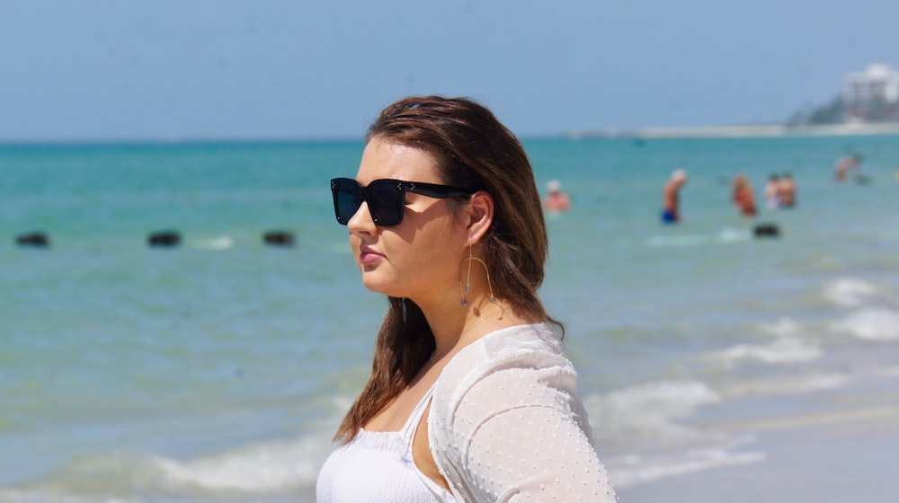 woman in white shirt wearing black sunglasses