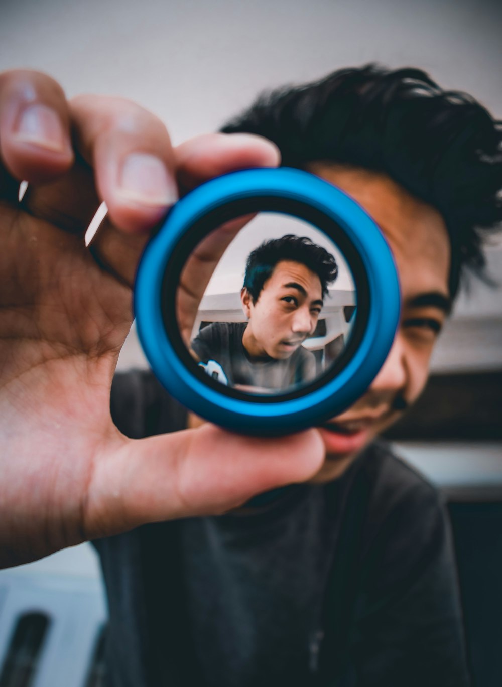 person holding blue round frame