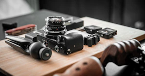 Imaging accessories including lenses and mounts arranged neatly on a white table.