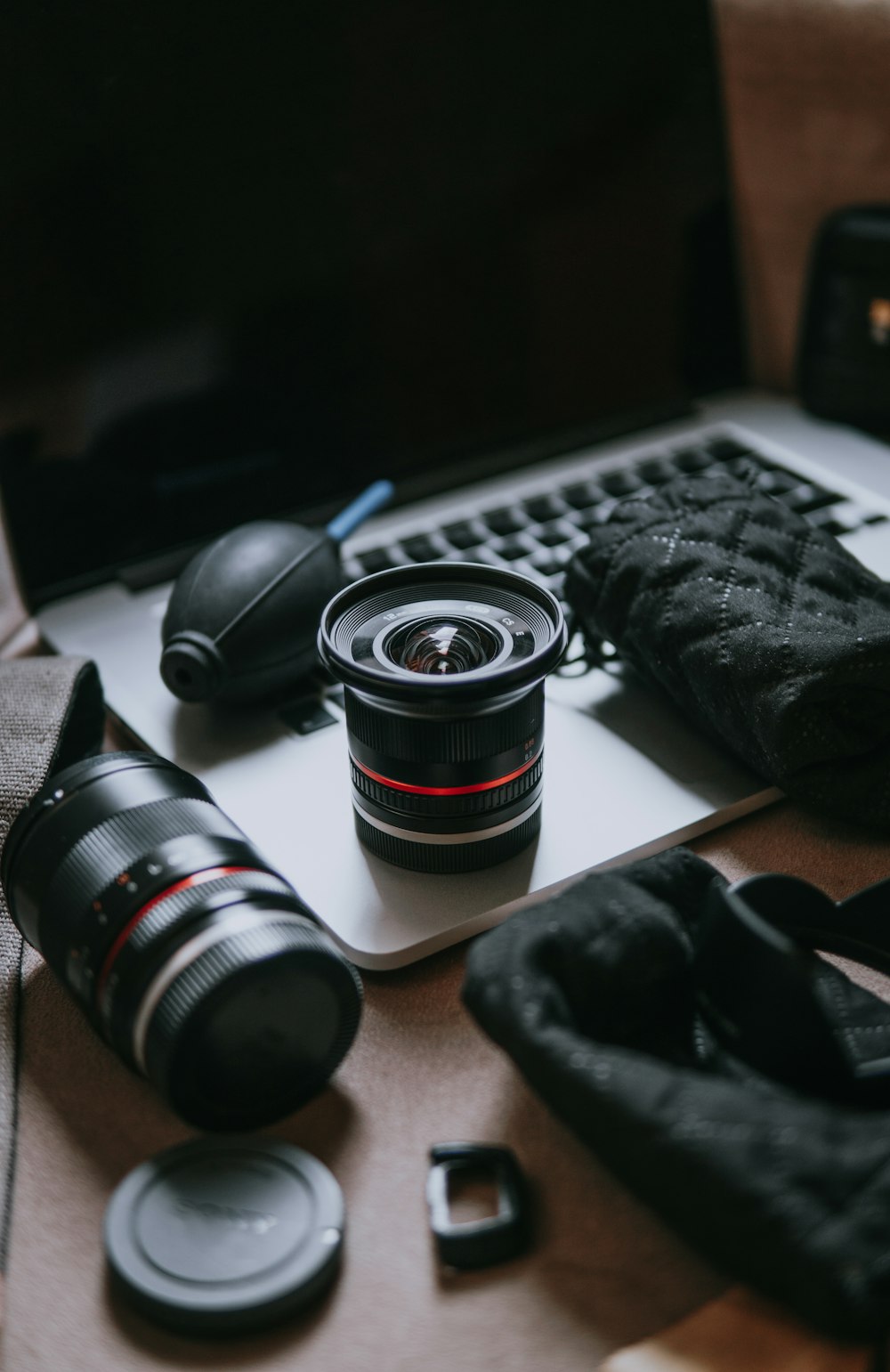 black and silver dslr camera lens on brown wooden table