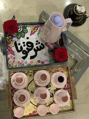 Elegant resin serving trays with soft beige and blush tones, styled with fresh flowers and minimalist tableware.